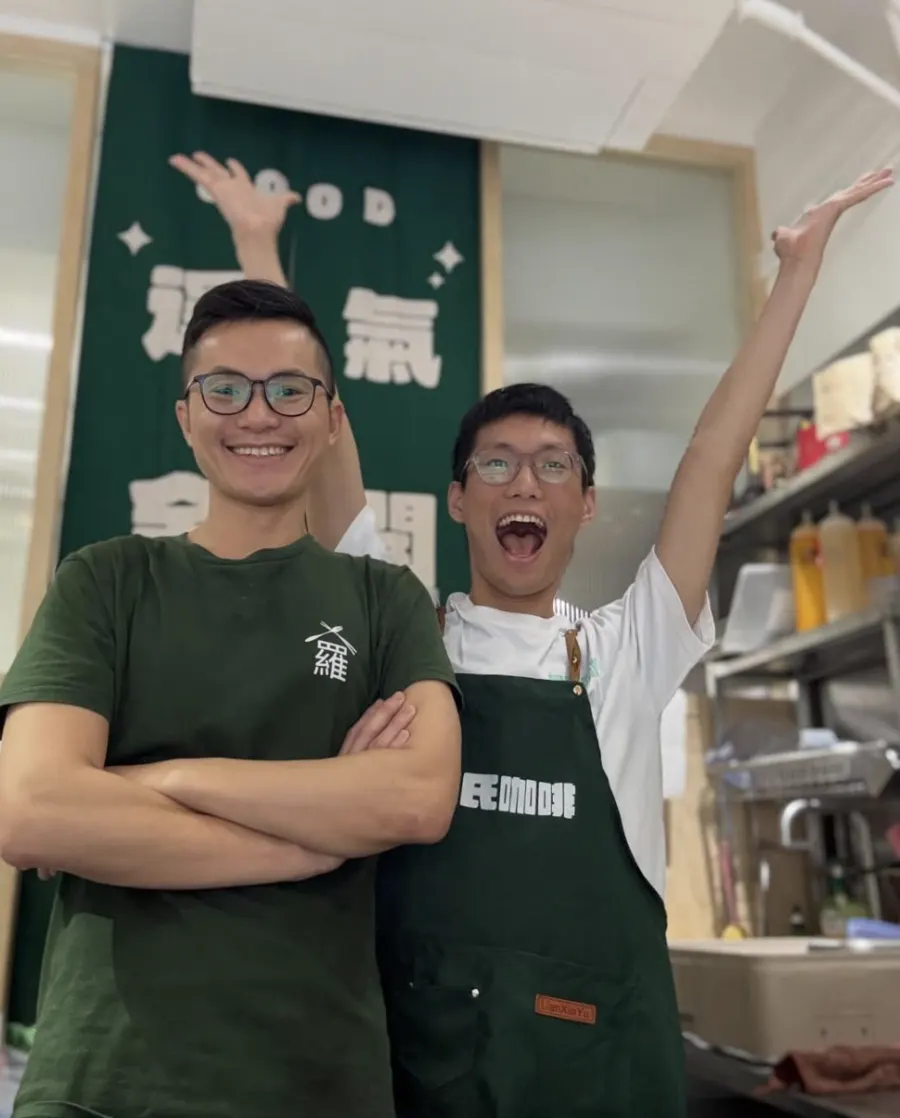 Lo's Taiwan team celebrating behind the bar in green Lo's aprons
